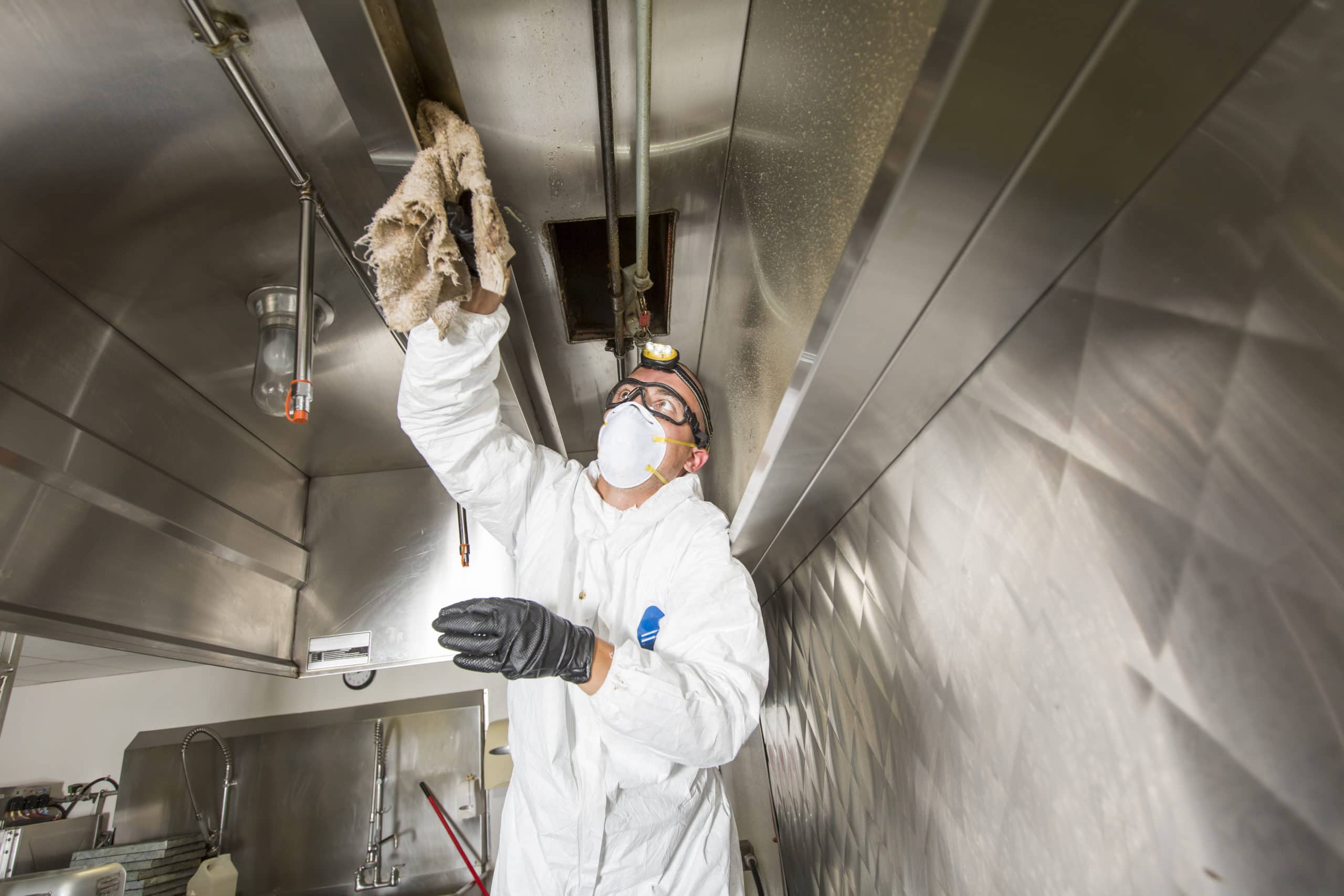 Florida kitchen pros performing hood cleaning service in a commercial kitchen