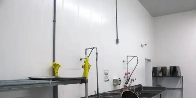 Commercial kitchen equipment with sinks and drying racks in Florida Kitchen Pros.