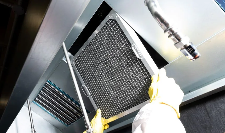 Grease filter removed from a commercial kitchen exhaust hood